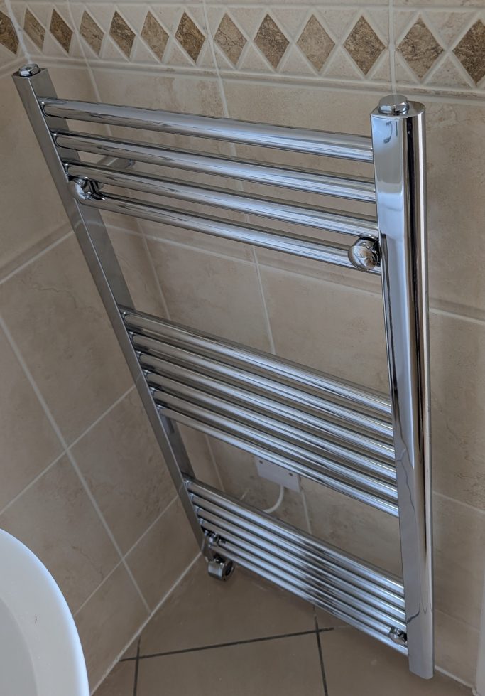 Electric towel rail installed in a domestic bathroom